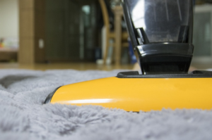 vacuuming the carpet